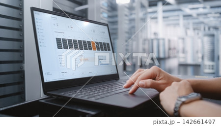 Female Network Engineer Reviewing Real Time Server Health and Data Center Infrastructure Status 142661497