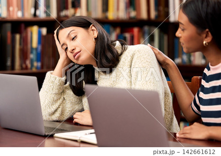University, stress and women with laptop, support or comfort at campus library with research, fear or burnout. Education, college or friends with help for overwhelmed girl with anxiety or self doubt University, stress and women with laptop, support or comfort at campus library with research, fear or burnout. Education, college or friends with help for overwhelmed girl with anxiety or self doubt 142661612