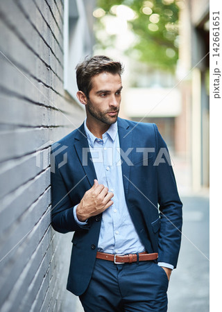 Businessman, fashion and wall with suit and confidence for career, clothing or trendy and cool. Male lawyer, city background and stylish or formal for job in corporate, legal with hands in Boston 142661651