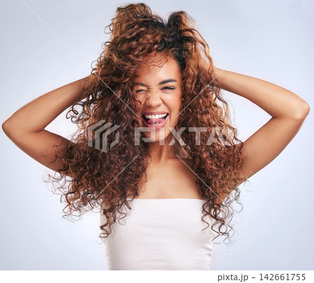 Beauty, hair or happy and portrait of woman in studio on gray background with tongue out expression. Salon, shampoo and smile with African model looking playful at aesthetic or cosmetology routine Beauty, hair or happy and portrait of woman in studio on gray background with tongue out expression. Salon, shampoo and smile with African model looking playful at aesthetic or cosmetology routine 142661755