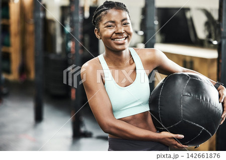 Fitness, medicine ball and portrait of black woman in gym for strength training or workout. Equipment, exercise and smile with happy sports athlete holding weight in health club for improvement 142661876