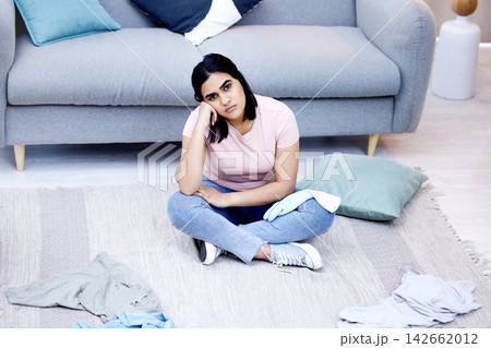 Woman, clothes and portrait on messy floor with tired, house work and laundry in apartment. Frustrated female cleaner, burnout and fatigue in living room for cleaning chaos with stress and overworked Woman, clothes and portrait on messy floor with tired, house work and laundry in apartment. Frustrated female cleaner, burnout and fatigue in living room for cleaning chaos with stress and overworked 142662012
