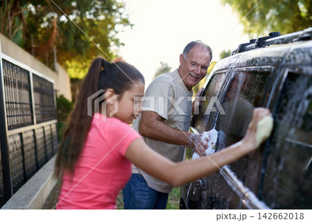 Father, child and car washing for cleaning, learning responsibility and development outdoor. Young girl, kid or teenager and dad for busy routine, childhood and cute for soapy water or fun on weekend Father, child and car washing for cleaning, learning responsibility and development outdoor. Young girl, kid or teenager and dad for busy routine, childhood and cute for soapy water or fun on weekend 142662018