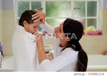 Sick, fever or mother and daughter with forehead check in a bathroom with flu, illness or problem. Comfort, worry and woman checking girl in bath towel for influenza, sign or fatigue after shower Sick, fever or mother and daughter with forehead check in a bathroom with flu, illness or problem. Comfort, worry and woman checking girl in bath towel for influenza, sign or fatigue after shower 142662124