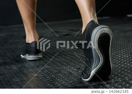 Fitness, foot and stretching with sports person in studio on dark background for start of workout. Exercise, warm up and wellness with back of athlete getting ready in health club for training 142662185