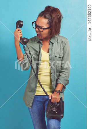 Telephone, angry and shouting with woman, stress and frustrated on blue studio background. Person, furious and girl with communication, rude or upset with emotion, screaming and aggressive with model 142662199