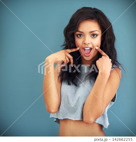 Fashion, portrait and surprise with trendy woman in studio isolated on blue background for casual style. Clothes, model and wow with cool, confident or shocked person in stylish clothing for reaction 142662255