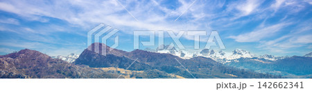 Mountain tops are covered with snow. Panorama of the mountains. National Park Peaks of Europe. Fuente De, Cantabria, Spain Mountain tops are covered with snow. Panorama of the mountains. National Park Peaks of Europe. Fuente De, Cantabria, Spain 142662341
