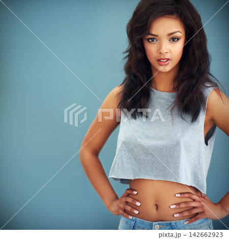 Attitude, fashion and mockup with portrait of woman in studio isolated on blue background for casual style. Clothes, model and space with cool, confident or trendy person in stylish clothing for chic 142662923