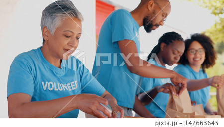 People volunteering, packaging food and donation for community service, poverty support and NGO management. Nonprofit, senior woman or group with groceries, helping outdoor or team in charity project People volunteering, packaging food and donation for community service, poverty support and NGO management. Nonprofit, senior woman or group with groceries, helping outdoor or team in charity project 142663645