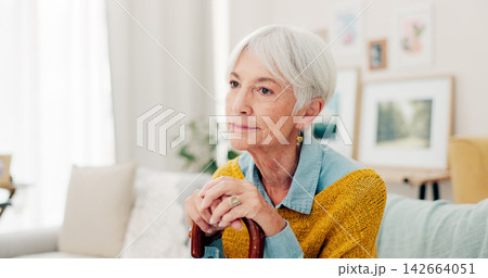 Couch, thinking and senior woman with a cane and a memory in home living room to relax on retirement. Lounge, walking stick and elderly person or pensioner with hope in a house or nursing facility Couch, thinking and senior woman with a cane and a memory in home living room to relax on retirement. Lounge, walking stick and elderly person or pensioner with hope in a house or nursing facility 142664051