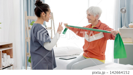 Elderly woman doing exercise with a resistance band for physical therapy with nurse in clinic. Fitness, healthcare and female patient doing arm workout with a physiotherapist in rehabilitation center Elderly woman doing exercise with a resistance band for physical therapy with nurse in clinic. Fitness, healthcare and female patient doing arm workout with a physiotherapist in rehabilitation center 142664152