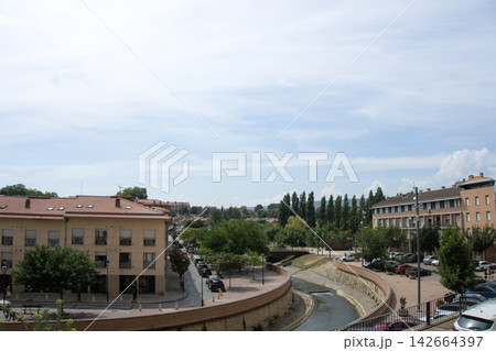Channelled Queiles river running through Tarazona beside a riverside promenade 142664397