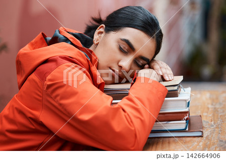 Sleeping, books and woman at table in library for education, tired or exhausted from studying. School, female person and university student for fatigue, rest or burnout for college examination 142664906