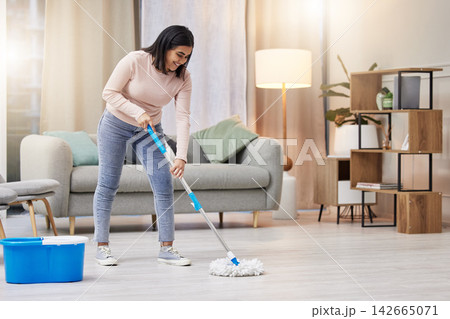 Happy, woman and cleaning floor in home with mop for hygiene with detergent for safety or protection from germs . Smile, housekeeper or service for health or wellness from virus or bacteria in lounge Happy, woman and cleaning floor in home with mop for hygiene with detergent for safety or protection from germs . Smile, housekeeper or service for health or wellness from virus or bacteria in lounge 142665071