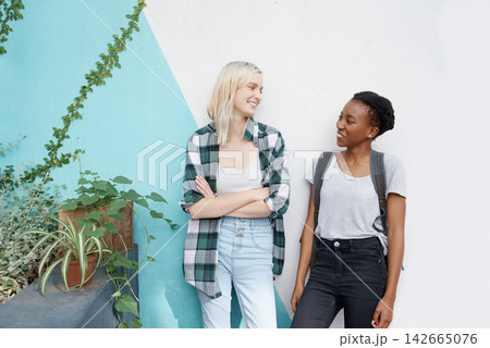 Women students, diversity and wall at university for talking together with friendship, scholarship and education. Global girls, chat and background at campus for learning with smile, study and class Women students, diversity and wall at university for talking together with friendship, scholarship and education. Global girls, chat and background at campus for learning with smile, study and class 142665076