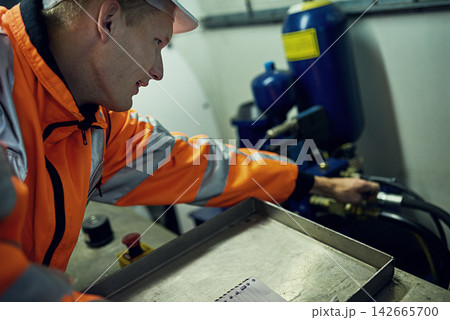 Generator, machine and man in electricity maintenance, engineering and industrial grid inspection. Renewable energy, production and technician checking electrical power system for quality assurance Generator, machine and man in electricity maintenance, engineering and industrial grid inspection. Renewable energy, production and technician checking electrical power system for quality assurance 142665700