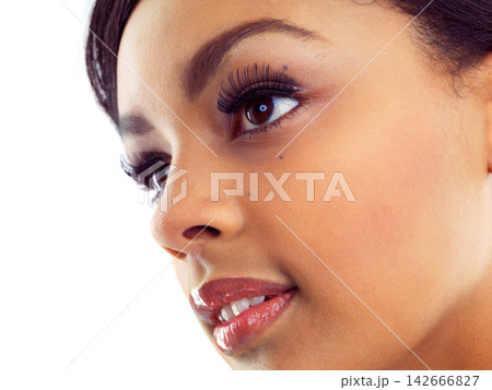 Black girl, makeup and closeup in studio for beauty with eye lashes, cosmetics and glowing lips for self care or confidence. Woman, isolated and white background with dermatology, glamour and shine. Black girl, makeup and closeup in studio for beauty with eye lashes, cosmetics and glowing lips for self care or confidence. Woman, isolated and white background with dermatology, glamour and shine. 142666827