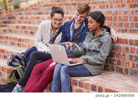 Happy, group of students and laptop, sitting or bonding with laptop outside on campus stairs. College people, smile and computer with teamwork and support for study help with education at university Happy, group of students and laptop, sitting or bonding with laptop outside on campus stairs. College people, smile and computer with teamwork and support for study help with education at university 142666906