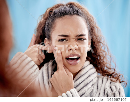 Acne, squeeze and woman in bathroom on mirror for skincare, self care and cosmetic treatment in morning. Hygiene, cleansing and girl popping pimple on cheek for blemish, spot and pore cleaning Acne, squeeze and woman in bathroom on mirror for skincare, self care and cosmetic treatment in morning. Hygiene, cleansing and girl popping pimple on cheek for blemish, spot and pore cleaning 142667105