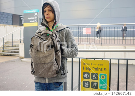 Young person wearing hidden disability sunflower lanyard in airport 142667142