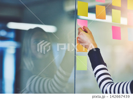 Person, hand and sticky note on glass wall for brainstorming research or startup, project planning or mind map. Fingers, paper and problem solving for company solution or goals, creative or target 142667439