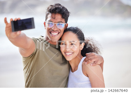 Beach, holiday and selfie of couple in hug with love, happiness and adventure in marriage. Summer, vacation and people post on social media with travel, photography or memory of honeymoon on island Beach, holiday and selfie of couple in hug with love, happiness and adventure in marriage. Summer, vacation and people post on social media with travel, photography or memory of honeymoon on island 142667640
