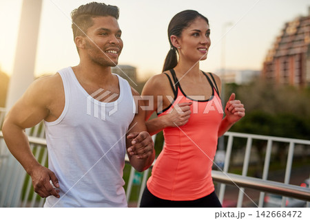 Couple, fitness and smile running outdoor for exercise, workout or cardio routine together on bridge. Happy, man and woman training or fast walking on road for strength, wellness and healthy bonding Couple, fitness and smile running outdoor for exercise, workout or cardio routine together on bridge. Happy, man and woman training or fast walking on road for strength, wellness and healthy bonding 142668472