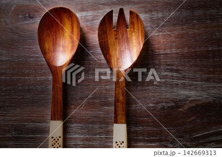 wood spoon and fork on wooden board 142669313