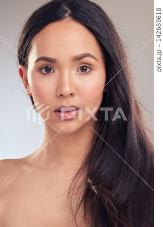 Woman, portrait and hair care in studio for health, wellness and skincare on gray background. Natural beauty, female person and treatment for sleek, shampoo and conditioner for keratin or growth Woman, portrait and hair care in studio for health, wellness and skincare on gray background. Natural beauty, female person and treatment for sleek, shampoo and conditioner for keratin or growth 142669618