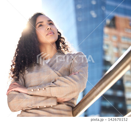 Crossed arms, thinking and business woman for ambition mindset, travel and morning commute. Corporate, professional worker and person with ideas in urban town for career, working and job opportunity 142670152