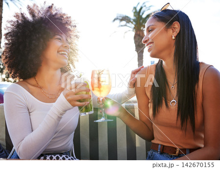 Girl friends, cheers and cocktail at bar with summer drink, alcohol and happy at a restaurant. Smile, bonding and women with toast to celebrate holiday and fun vacation in Miami with beverage 142670155