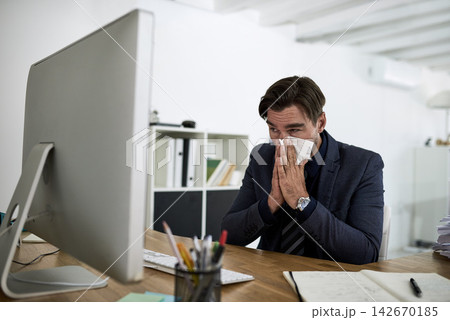 Sinus, sneeze and business man in office with allergies, blowing nose and virus working at desk. Corporate worker, healthcare and person with tissue for illness, cold and flu sneeze in workplace 142670185