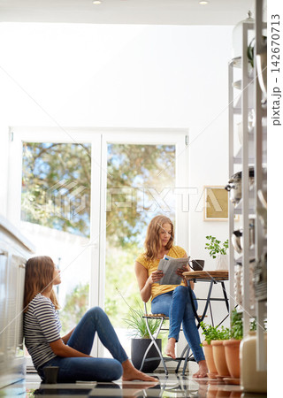 Relax, morning and sisters in kitchen with coffee for breakfast conversation, bonding and happiness. Women, twins weekend chat with news, discussion and sitting together in home for social connection 142670713