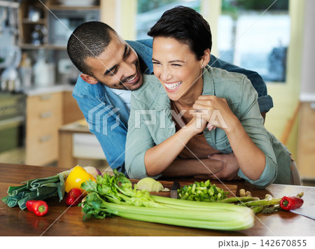 Cooking, smile and couple embrace at kitchen counter for preparation, healthy food and bonding together on date. Vegetables, happy man and vegan woman for dinner, nutrition meal or love in home Cooking, smile and couple embrace at kitchen counter for preparation, healthy food and bonding together on date. Vegetables, happy man and vegan woman for dinner, nutrition meal or love in home 142670855