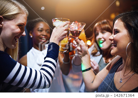 Women, happy and cheers in club for party or event for nightlife, bonding and friendship with fun or laughter. Alcohol, toast and raising cocktail with excitement for celebration, together and drink Women, happy and cheers in club for party or event for nightlife, bonding and friendship with fun or laughter. Alcohol, toast and raising cocktail with excitement for celebration, together and drink 142671364