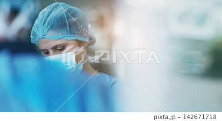 Health, surgery and doctor with face mask and scrubs in theatre for medical procedure and emergency. Female person or healthcare professional in operating room for diagnosis and wound dressing Health, surgery and doctor with face mask and scrubs in theatre for medical procedure and emergency. Female person or healthcare professional in operating room for diagnosis and wound dressing 142671718