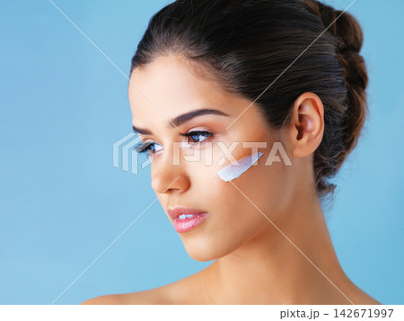 Thinking, skincare and girl with face cream in studio mockup for wellness, cosmetics or skin detox on blue background. Beauty, sunscreen or model with how to, tips or diy makeup removal product idea Thinking, skincare and girl with face cream in studio mockup for wellness, cosmetics or skin detox on blue background. Beauty, sunscreen or model with how to, tips or diy makeup removal product idea 142671997