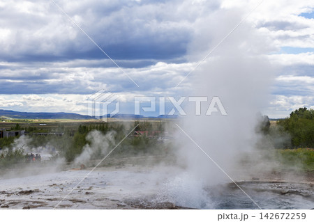 Strokkur geyser steam plume above wet mineral ground in Haukadalur, Iceland Strokkur geyser steam plume above wet mineral ground in Haukadalur, Iceland 142672259