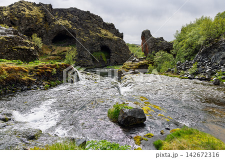 Rauda River flowing through lava formations across Gjain, Iceland, balanced river and lava Rauda River flowing through lava formations across Gjain, Iceland, balanced river and lava 142672316