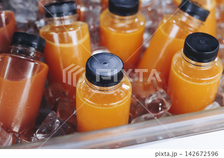 Hallabong orange juice, freshly squeezed made from Jeju tangerine gamgyul fruits, juice in bottles for sale, farm market shop, Jeju Island, South Korea, chilled citrus drink sold at local kiosk market 142672596