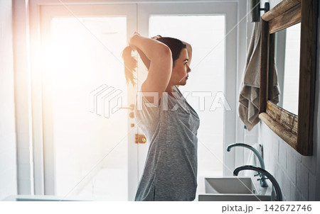 Beauty, mirror and girl with hair check in bathroom for morning, start and routine in her home. Hairstyle, profile and woman in house with haircare reflection for ponytail, cosmetics or getting ready 142672746