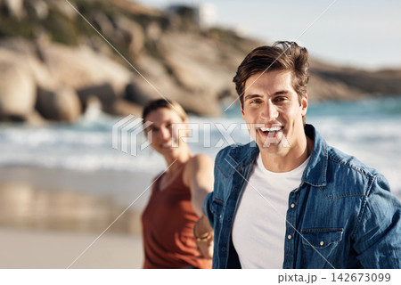 Couple, portrait and man holding hands at beach in summer, holiday or journey on vacation. Happy, travel and woman follow partner with smile on face on island and adventure in marriage on date Couple, portrait and man holding hands at beach in summer, holiday or journey on vacation. Happy, travel and woman follow partner with smile on face on island and adventure in marriage on date 142673099
