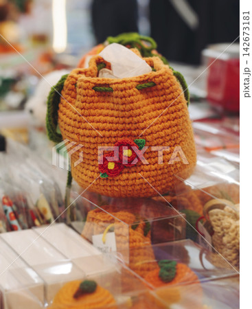 Tourist gifts and Korean souvenirs from Jeju Island, Jeju-do, South Korea, tangerine hallabong figures in orange color, knitted toys, fridge magnets, key ring keychain, a local gift vendor shop market Tourist gifts and Korean souvenirs from Jeju Island, Jeju-do, South Korea, tangerine hallabong figures in orange color, knitted toys, fridge magnets, key ring keychain, a local gift vendor shop market 142673181