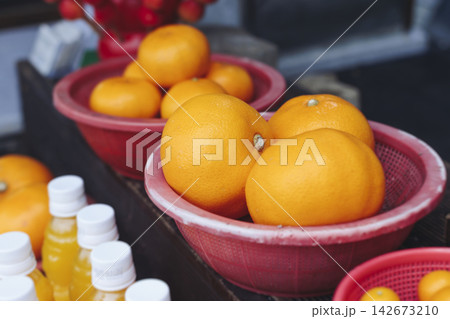 Hallabong orange juice, freshly squeezed made from Jeju tangerine gamgyul fruits, juice in bottles for sale, farm market shop, Jeju Island, South Korea, chilled citrus drink sold at local kiosk market 142673210