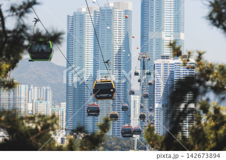 Busan Air Cruise, Busan cable car, ride on multicoloured sky capsule gondola route, with Songdo beach and Skywalk and Busan Bay panorama, South Korea, Songdo Station in a spring sunny day 142673894