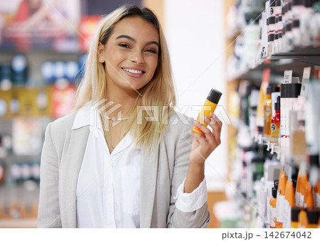 Woman, shopping and portrait with product in cosmetics, store and customer at sale for discount. Retail, promotion and girl search shelf in mall for skincare, makeup and hair care in beauty aisle Woman, shopping and portrait with product in cosmetics, store and customer at sale for discount. Retail, promotion and girl search shelf in mall for skincare, makeup and hair care in beauty aisle 142674042