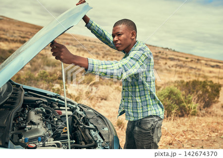 Black man, engine and check car hood on road, outdoor and roadside assistance for auto service. Male person, battery and power issue with vehicle on street, cables and driver for transport emergency Black man, engine and check car hood on road, outdoor and roadside assistance for auto service. Male person, battery and power issue with vehicle on street, cables and driver for transport emergency 142674370