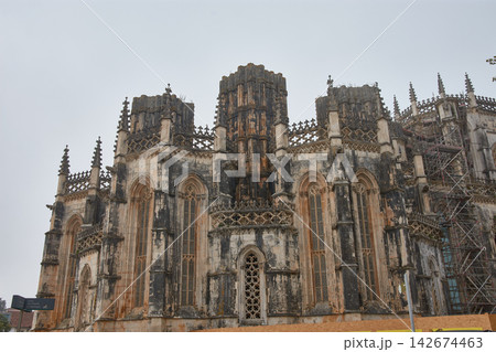 Batalha Monastery with Gothic facades and detailed sculptures in the foreground in a historic setting and heritage restoration Batalha Monastery with Gothic facades and detailed sculptures in the foreground in a historic setting and heritage restoration 142674463