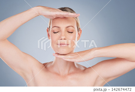 Skincare, woman and hands to frame face on studio background for dermatology or beauty. Facial, treatment and model gesture with antiaging cosmetics for healthy glow on skin, texture and aesthetic 142674472
